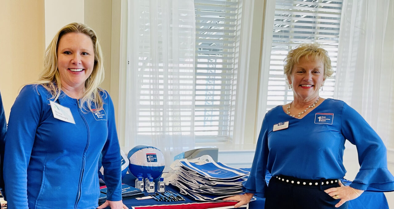 Two women members at one of our events with sponsors